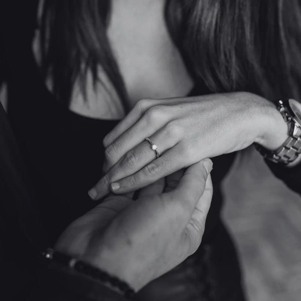 Kvinna som visar upp en diamantring för en man.