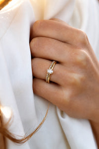 Set med förlovningsring och vigselring i guld med oval diamant och alliansring